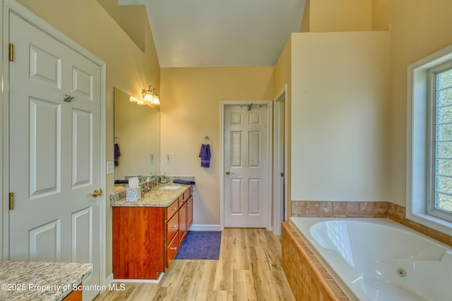 157 Mcesther Dr Unit L 31, Covington Twp, PA 18424 - full bath with double vanity, a jetted tub, healthy amount of natural light, and wood finished floors