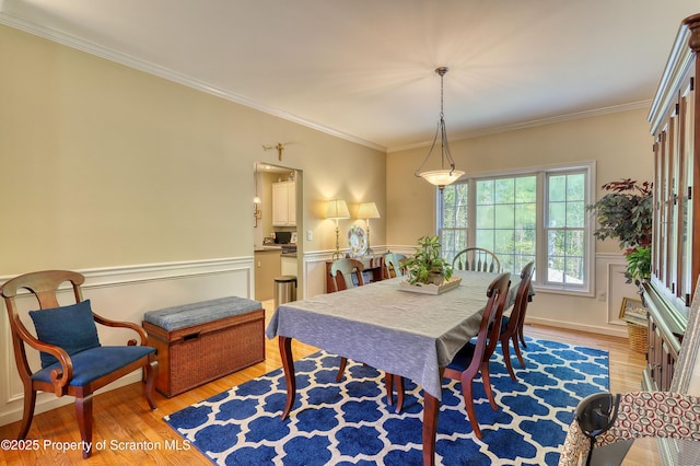 157 Mcesther Dr Unit L 31, Covington Twp, PA 18424 - dining room featuring light wood finished floors, crown molding, and a wainscoted wall