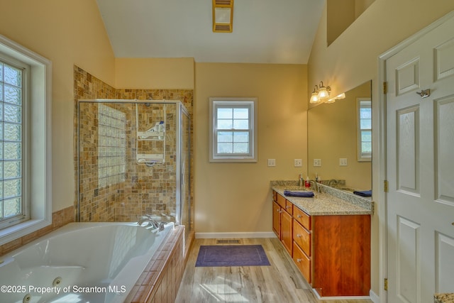 157 Mcesther Dr Unit L 31, Covington Twp, PA 18424 - bathroom with vaulted ceiling, a stall shower, a jetted tub, and vanity