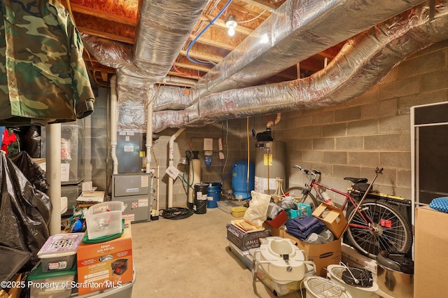 157 Mcesther Dr Unit L 31, Covington Twp, PA 18424 - unfinished basement featuring water heater, a water pressure tank, and concrete block wall