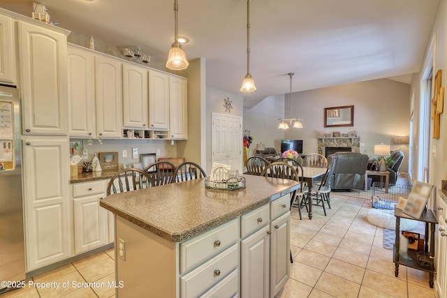 157 Mcesther Dr Unit L 31, Covington Twp, PA 18424 - kitchen with light tile patterned floors, a kitchen island, decorative light fixtures, and open floor plan