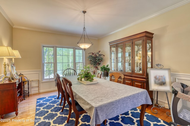 157 Mcesther Dr Unit L 31, Covington Twp, PA 18424 - dining area with light wood finished floors, a wainscoted wall, and crown molding