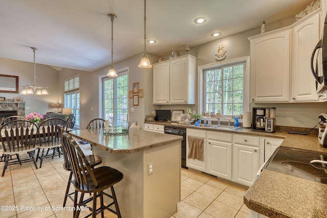 157 Mcesther Dr Unit L 31, Covington Twp, PA 18424 - kitchen featuring black dishwasher, light tile patterned floors, plenty of natural light, white cabinets, and recessed lighting