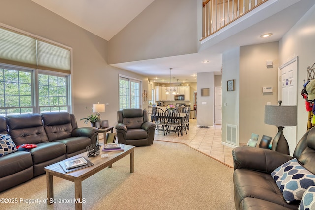157 Mcesther Dr Unit L 31, Covington Twp, PA 18424 - living area featuring a chandelier, high vaulted ceiling, light tile patterned floors, light carpet, and recessed lighting