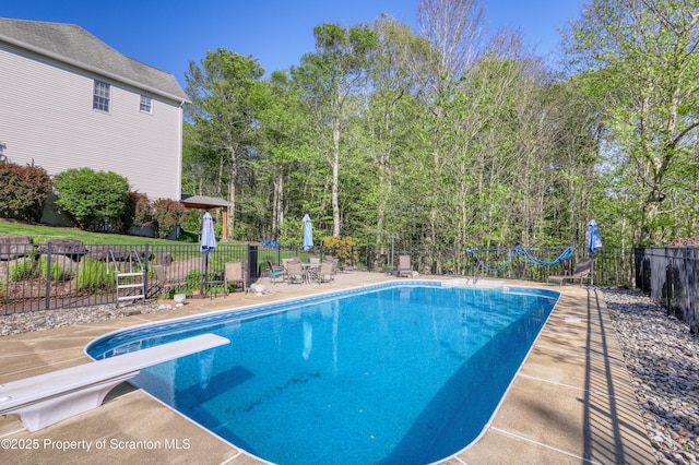 157 Mcesther Dr Unit L 31, Covington Twp, PA 18424 - view of swimming pool featuring a diving board and a patio area