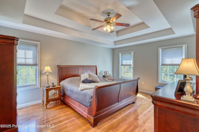 157 Mcesther Dr Unit L 31, Covington Twp, PA 18424 - bedroom featuring a raised ceiling, multiple windows, and light wood finished floors