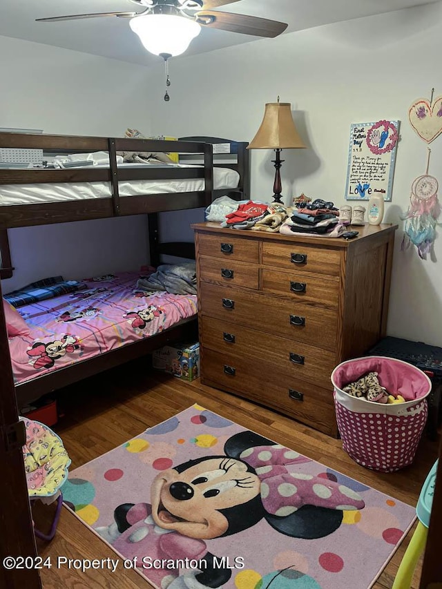 bedroom with ceiling fan and wood-type flooring