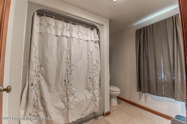 bathroom with tile patterned flooring and toilet