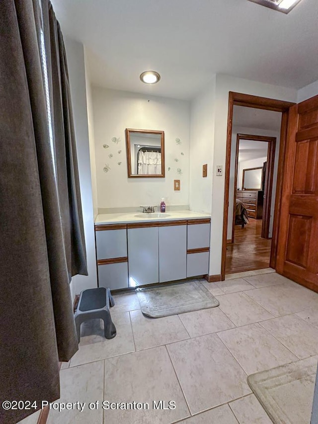 bathroom featuring tile patterned flooring and vanity