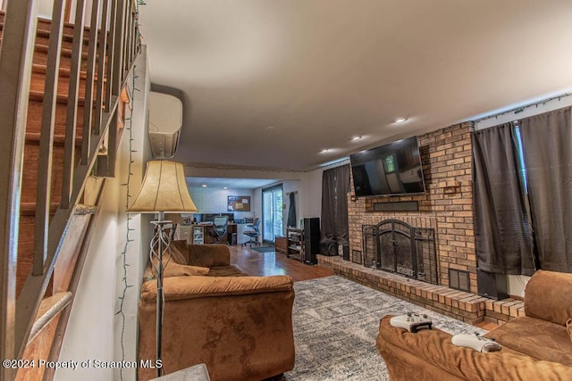 living room with hardwood / wood-style floors and a brick fireplace