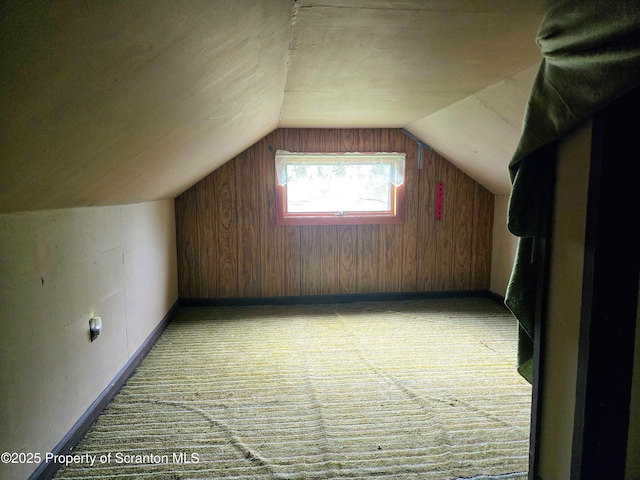 additional living space with vaulted ceiling, carpet flooring, and baseboards