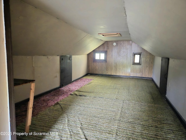 additional living space with lofted ceiling, carpet flooring, and baseboards