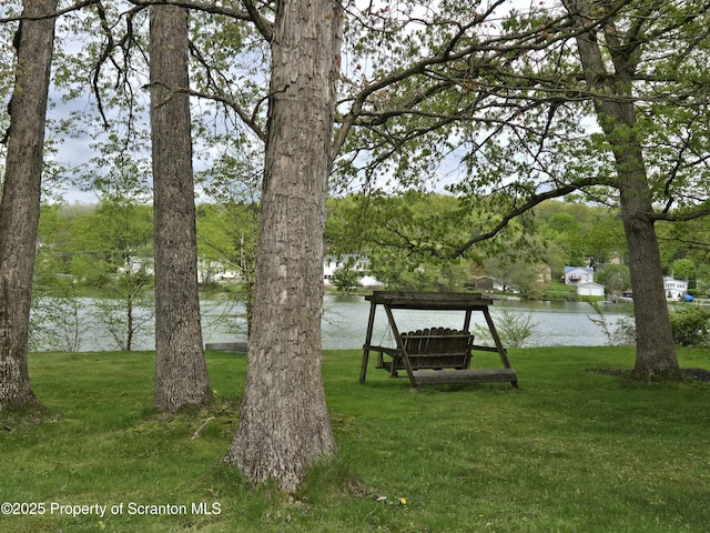 view of grassy yard with a water view
