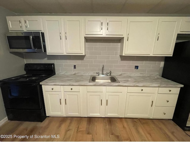 1034 Plane St, Avoca, PA 18641 - kitchen with a sink, tasteful backsplash, black appliances, and wood finished floors