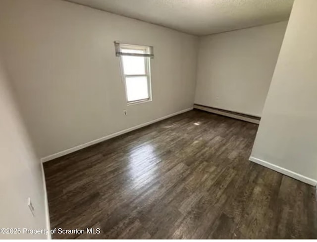 1034 Plane St, Avoca, PA 18641 - empty room with baseboards, a baseboard radiator, a textured ceiling, and wood finished floors