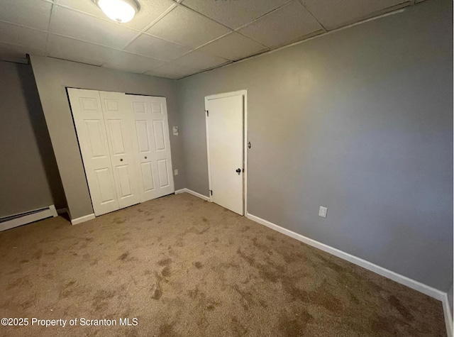 1034 Plane St, Avoca, PA 18641 - unfurnished bedroom featuring a paneled ceiling, baseboards, a baseboard radiator, a closet, and carpet flooring