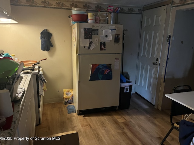 1034 Plane St, Avoca, PA 18641 - kitchen with baseboards, freestanding refrigerator, and wood finished floors