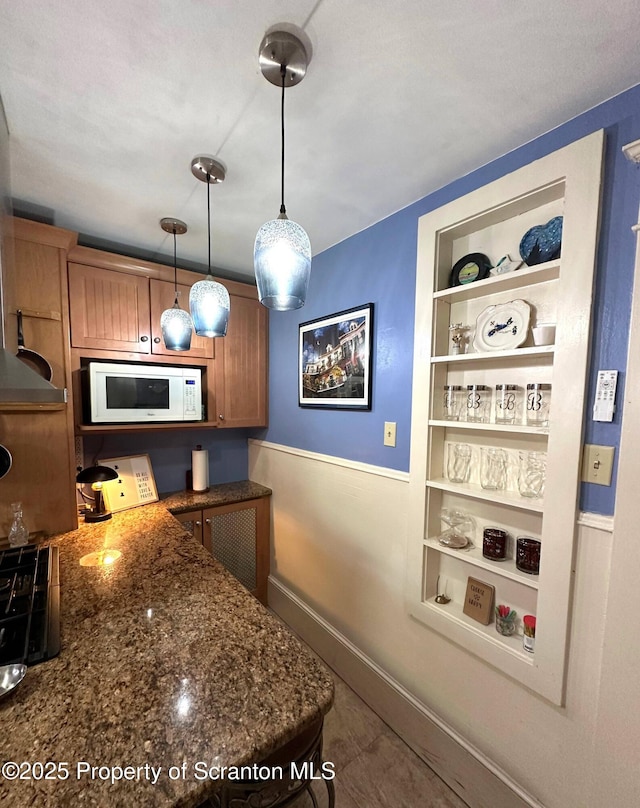 1747 Monsey Ave, Scranton, PA 18509 - kitchen featuring white microwave, built in shelves, pendant lighting, dark stone countertops, and baseboards