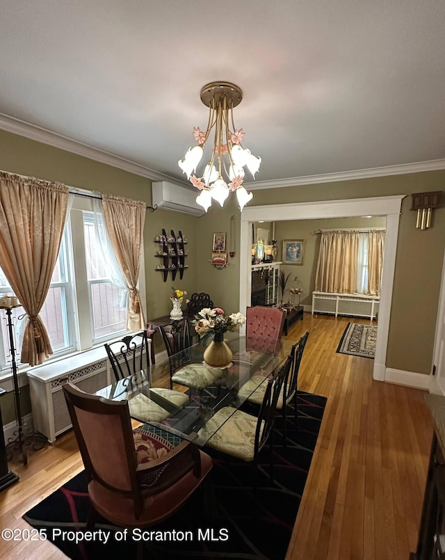 1747 Monsey Ave, Scranton, PA 18509 - dining room with an AC wall unit, crown molding, light wood finished floors, a chandelier, and baseboards