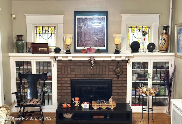 1747 Monsey Ave, Scranton, PA 18509 - living room with plenty of natural light, wood finished floors, and a brick fireplace