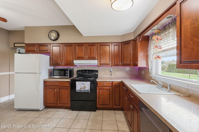 kitchen featuring stainless steel appliances, a sink, light tile patterned flooring, extractor fan, and light countertops
