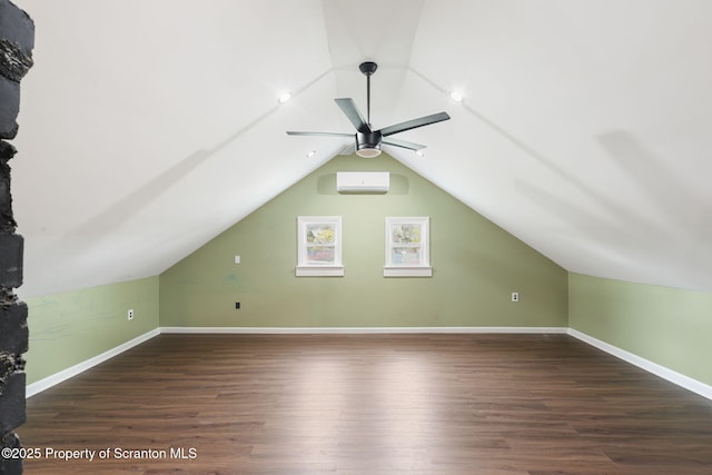 additional living space with a wall mounted air conditioner, ceiling fan, lofted ceiling, and wood finished floors