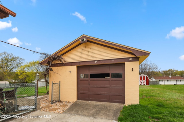 garage featuring fence and driveway