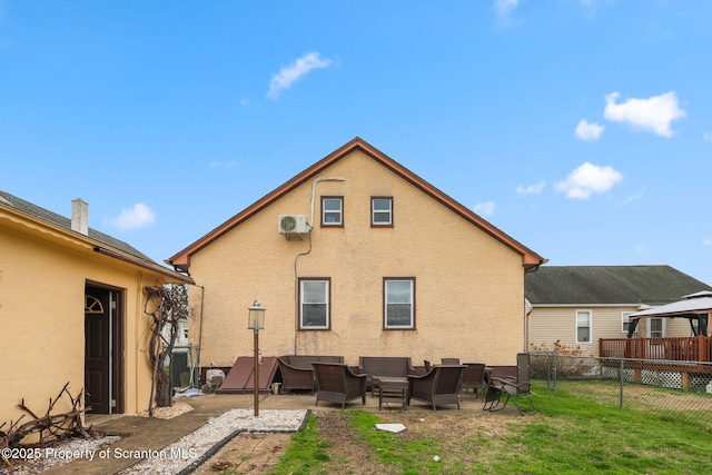 back of house featuring stucco siding, a yard, a patio area, and fence