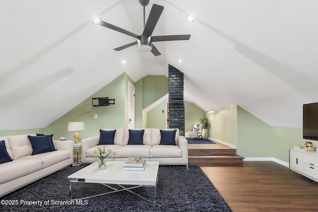 living room with wood finished floors, lofted ceiling, baseboards, and ceiling fan