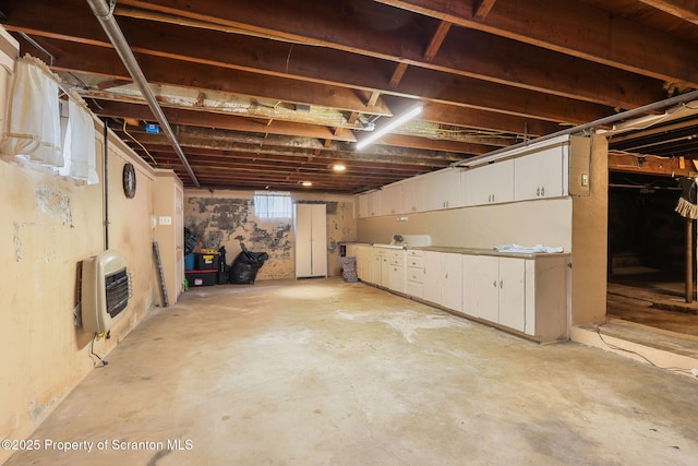 unfinished below grade area featuring heating unit