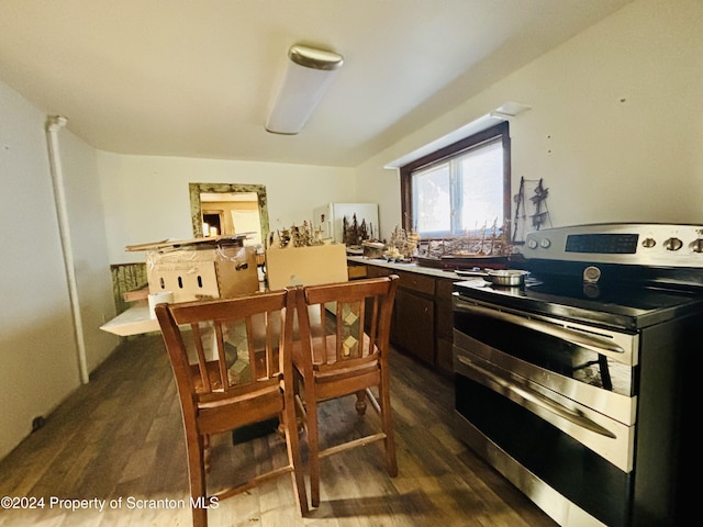 kitchen with dark brown cabinets, stainless steel electric range oven, and dark wood-type flooring