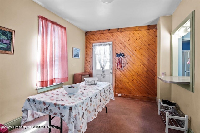 carpeted bedroom with wooden walls