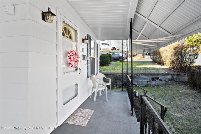 view of patio / terrace with a carport and covered porch