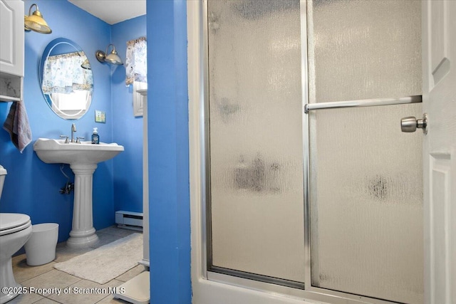 full bath featuring tile patterned floors, toilet, a stall shower, and baseboard heating