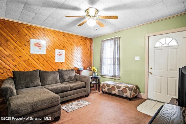 carpeted living room featuring ceiling fan and ornamental molding