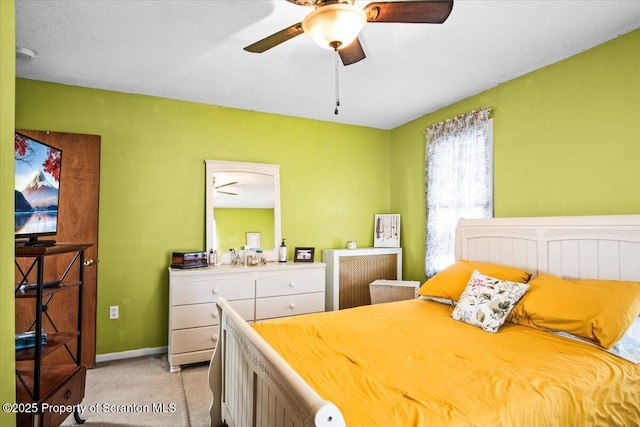 bedroom with baseboards, light carpet, and ceiling fan