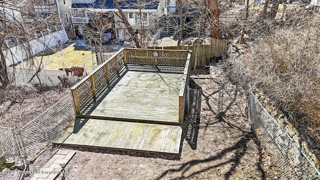 view of community featuring a wooden deck and fence