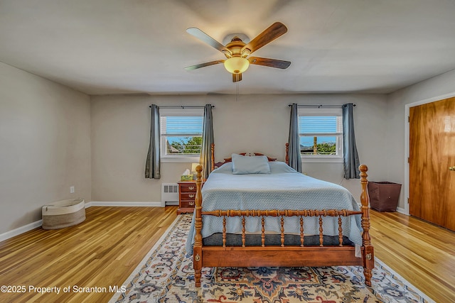 201 Franklin St, Dunmore, PA 18512 - bedroom with radiator, multiple windows, wood finished floors, and ceiling fan