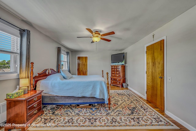 201 Franklin St, Dunmore, PA 18512 - bedroom with wood finished floors, ceiling fan, and radiator