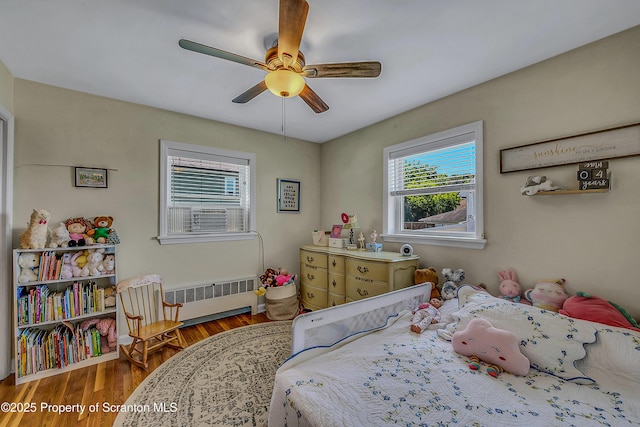 201 Franklin St, Dunmore, PA 18512 - bedroom featuring radiator heating unit, wood finished floors, and a ceiling fan