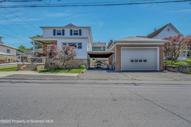 201 Franklin St, Dunmore, PA 18512 - traditional-style home featuring a porch, a garage, brick siding, and asphalt driveway