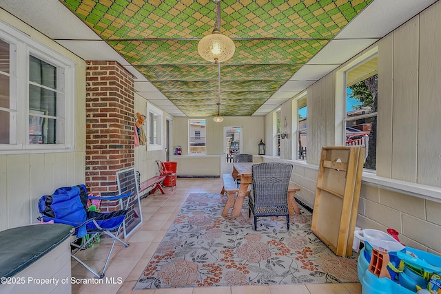 201 Franklin St, Dunmore, PA 18512 - sunroom / solarium with tile patterned floors, outdoor dining area, and wooden walls
