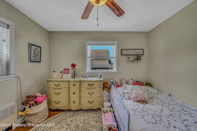 201 Franklin St, Dunmore, PA 18512 - bedroom with radiator, wood finished floors, and ceiling fan