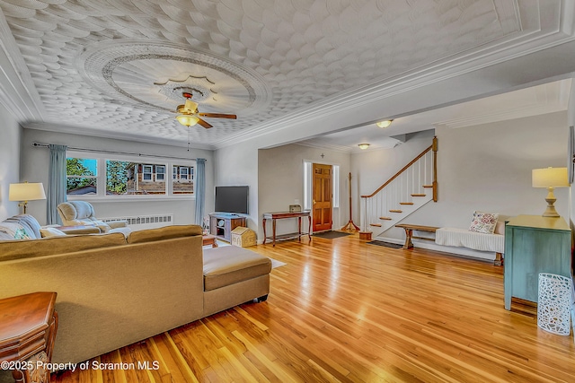 201 Franklin St, Dunmore, PA 18512 - living room featuring light wood-type flooring, ornamental molding, ceiling fan, stairs, and a tray ceiling