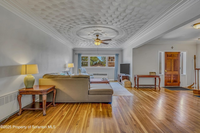 201 Franklin St, Dunmore, PA 18512 - living room with radiator, a ceiling fan, wood finished floors, and ornamental molding