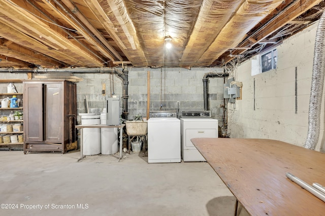 basement featuring independent washer and dryer and sink