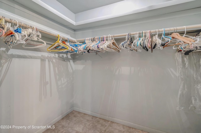 walk in closet with light tile patterned floors