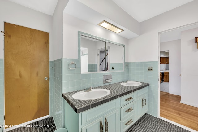 bathroom featuring tile patterned floors, vanity, and tile walls