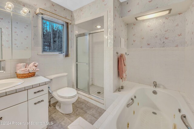 full bathroom featuring tile patterned floors, vanity, separate shower and tub, and toilet