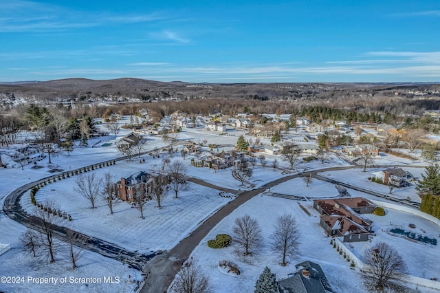 snowy aerial view featuring a mountain view